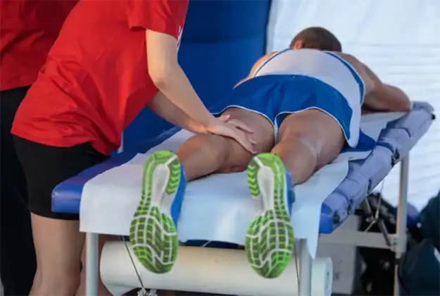 Sports massage therapy on athlete's leg